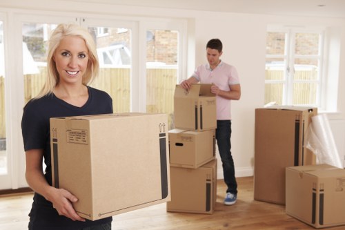 Staff handling boxes safely in a moving environment