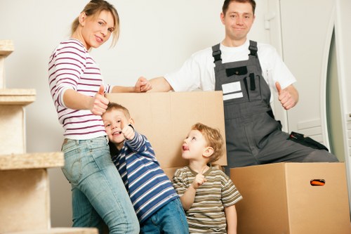 Professional movers carrying furniture from a local home
